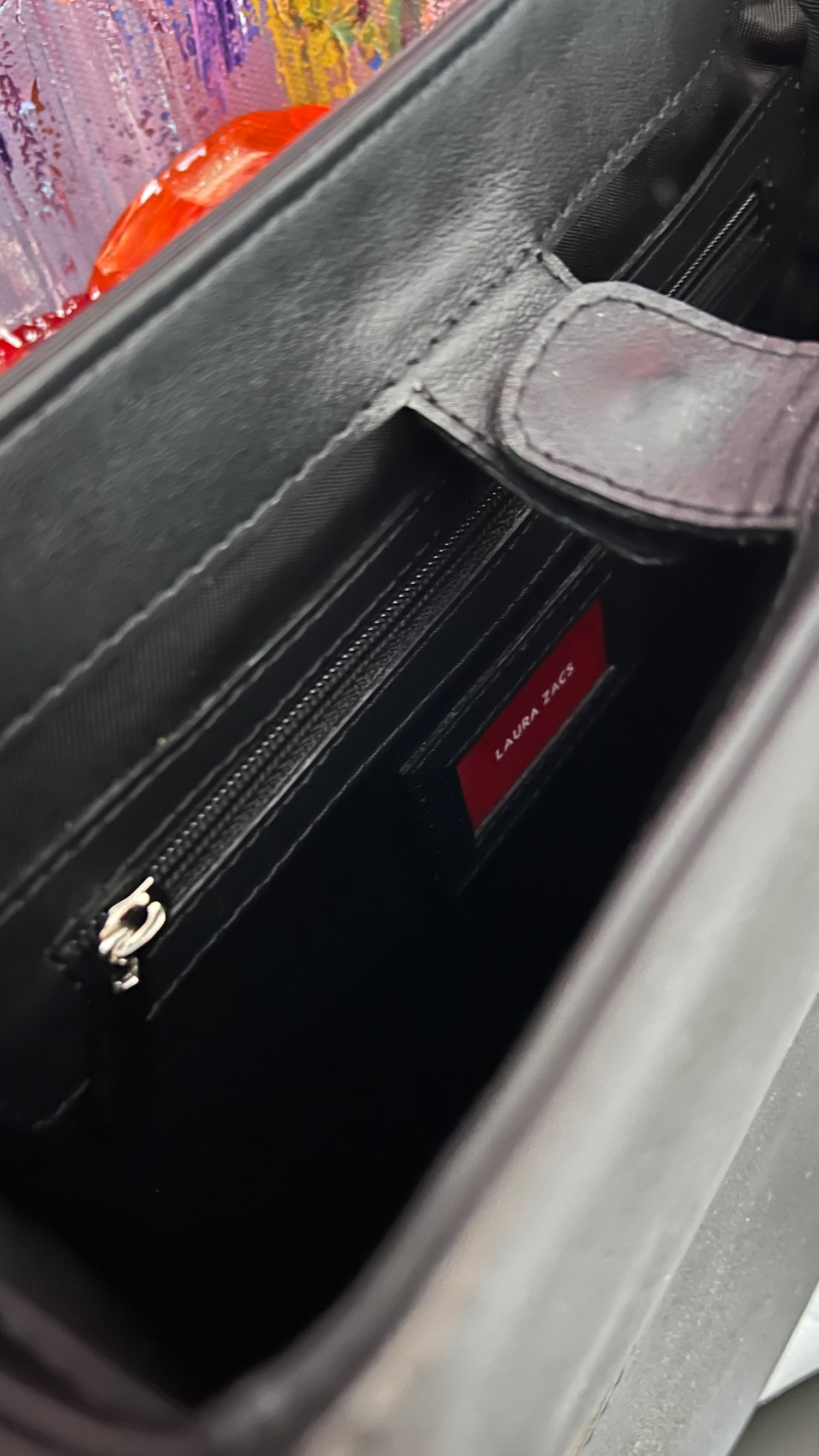 inside details of a black leather shoulder bag